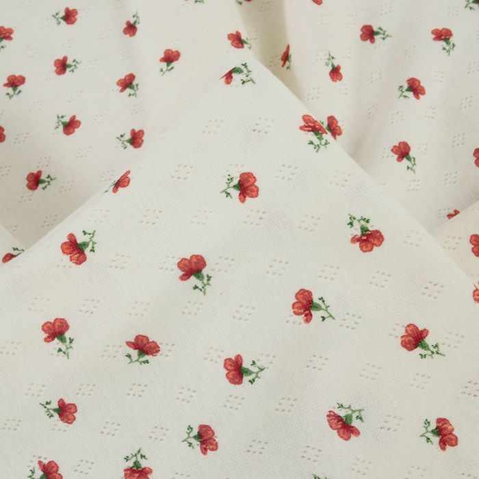 Tissu jersey ajouré pointelle fleurs - écru x 10 cm