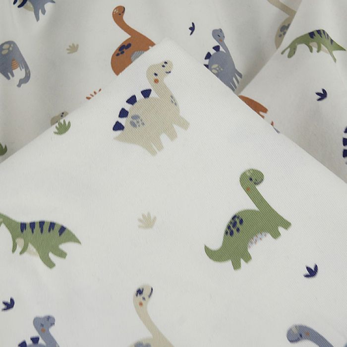 Tissu jersey fin dinosaures - écru x 10 cm